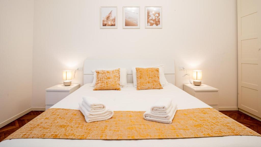 a bedroom with a white bed with two lamps at Ramazzini District – Elegant Flat x8 in Milan