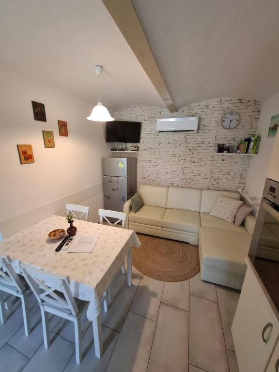 a living room with a table and a couch at Helena in Trzin