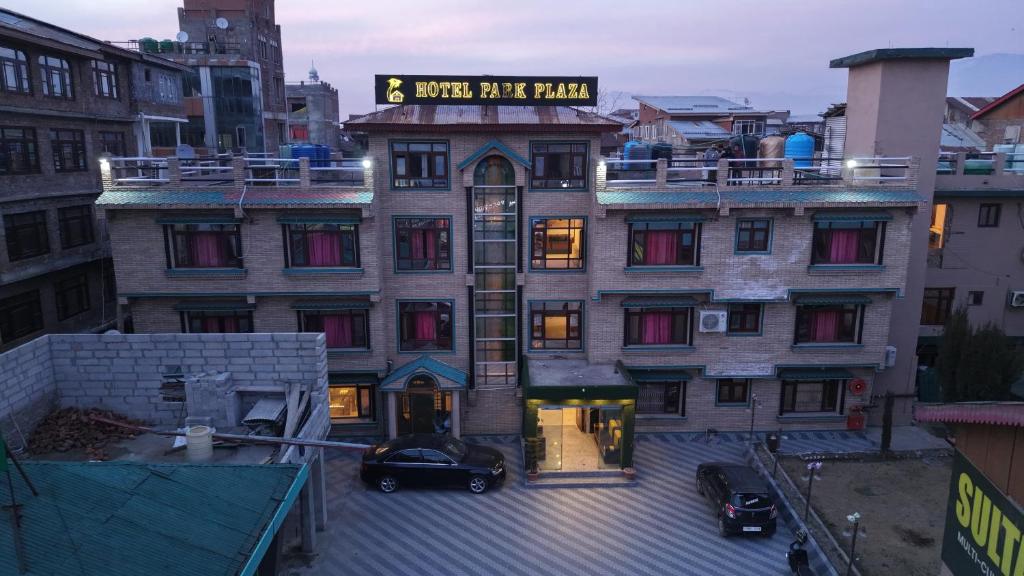 a large building with a sign on top of it at Hotel Park Plaza Srinagar in Srinagar