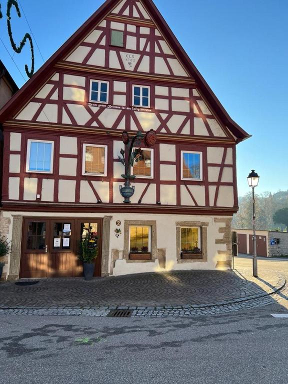 a large building with a large gambrel at Gasthaus Rose in Niedernhall
