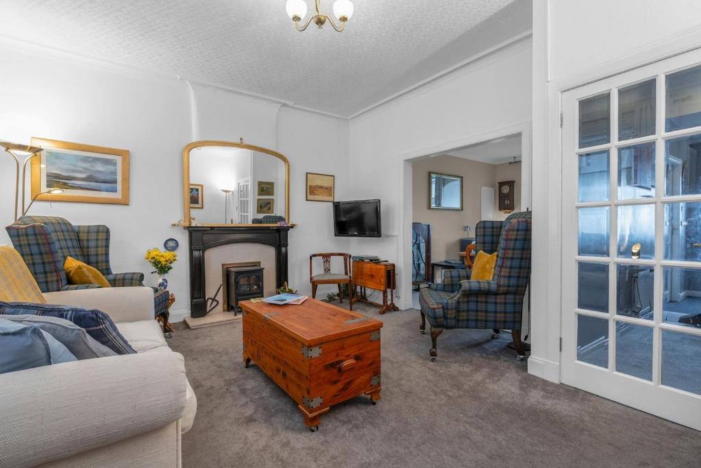 a living room with a couch and a fireplace at Fisherman's Cottage in Cockenzie