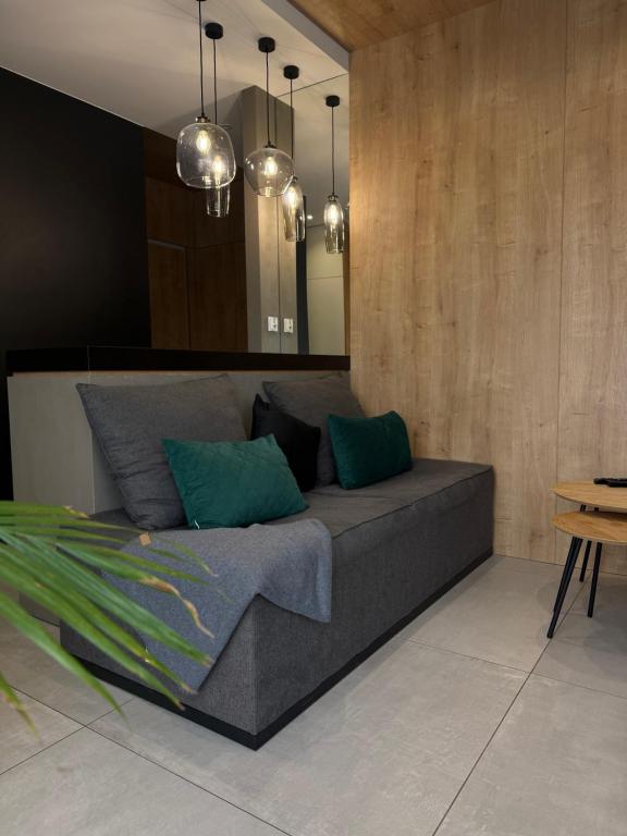 a living room with a couch with green pillows at ALEKSANDRA 5 - Leaf in Kielce