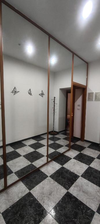 an empty room with a checkered floor at Silvia Butterfly Flat in Genoa