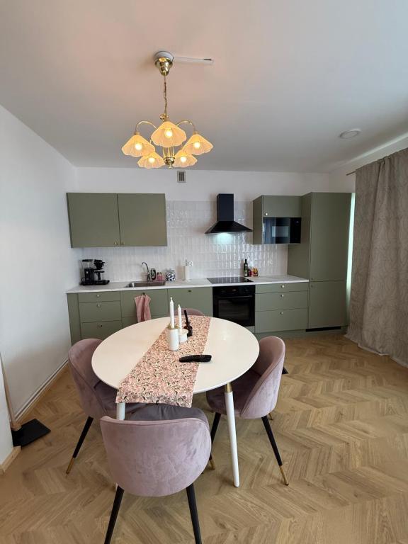 a kitchen with a table and chairs in a room at Central Kauppakatu Apartment in Joensuu