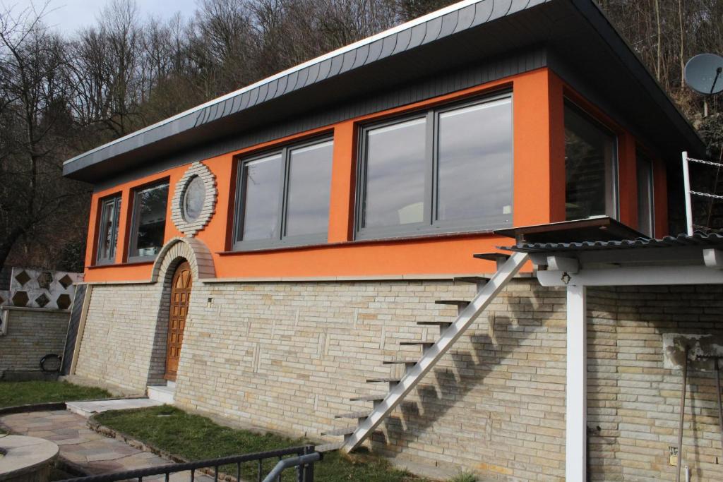 an orange and black house on a brick building at Bungalow Schönblick in Pirna