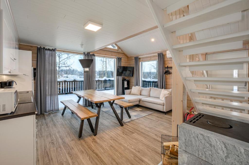 a living room with a table and a couch at Villa Breikki Himos - Alpha & Bravo Incl WiFi, Sauna, Jacuzzi for extra fee in Jämsä
