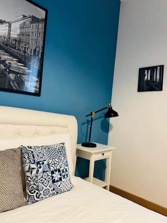 a bedroom with a bed and a lamp on a table at My Way Rooms - Affittacamere in centro Trieste in Trieste