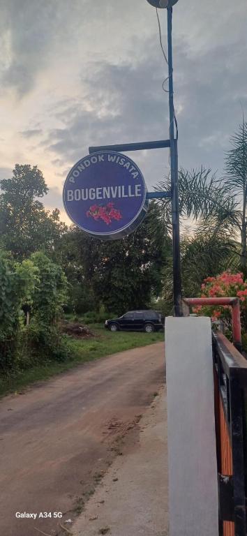 a sign for a bus stop on the side of a road at BougenVille in Labu Pumi
