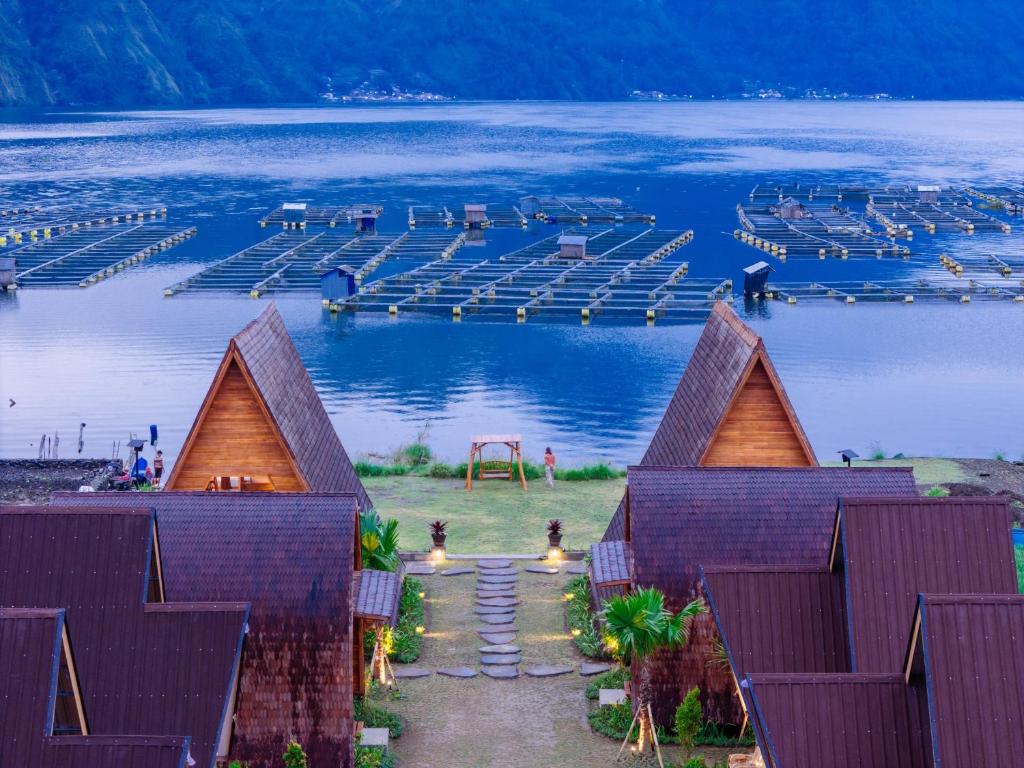 a view of a body of water with a dock at The Dewi Tasik Kintamani Cabin and Villa in Kubupenlokan