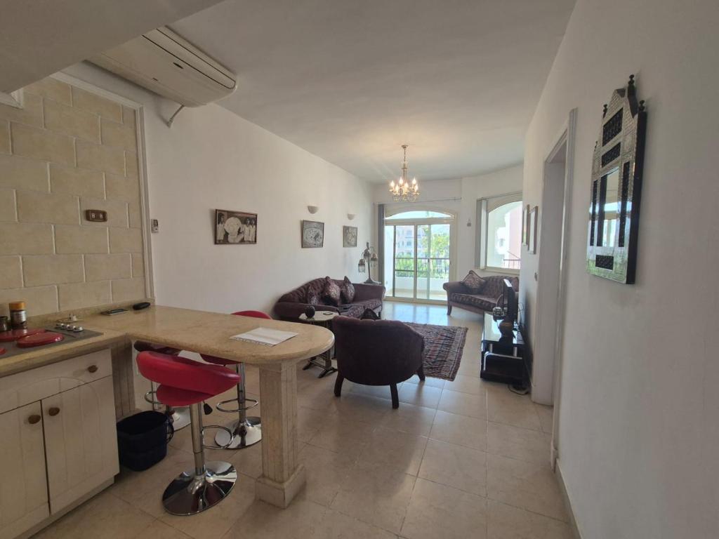 a kitchen and living room with a table and chairs at K31 Peaceful 2 Bedrooms Nile Resort Flat in Luxor in Luxor