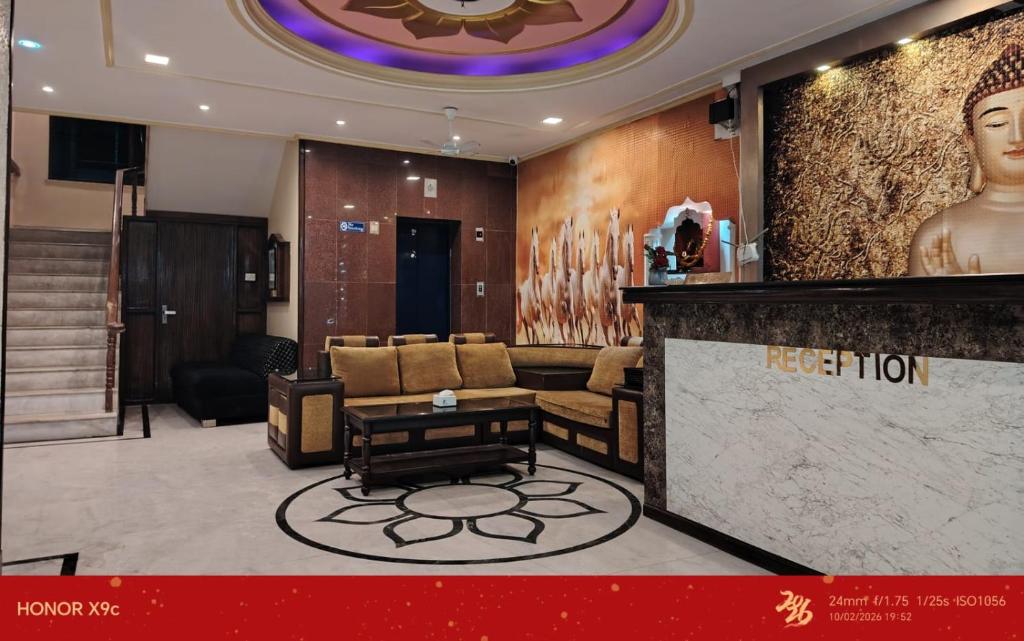 a lobby with a bar with a couch and a table at Hotel Black and White International in Bhairāhawā