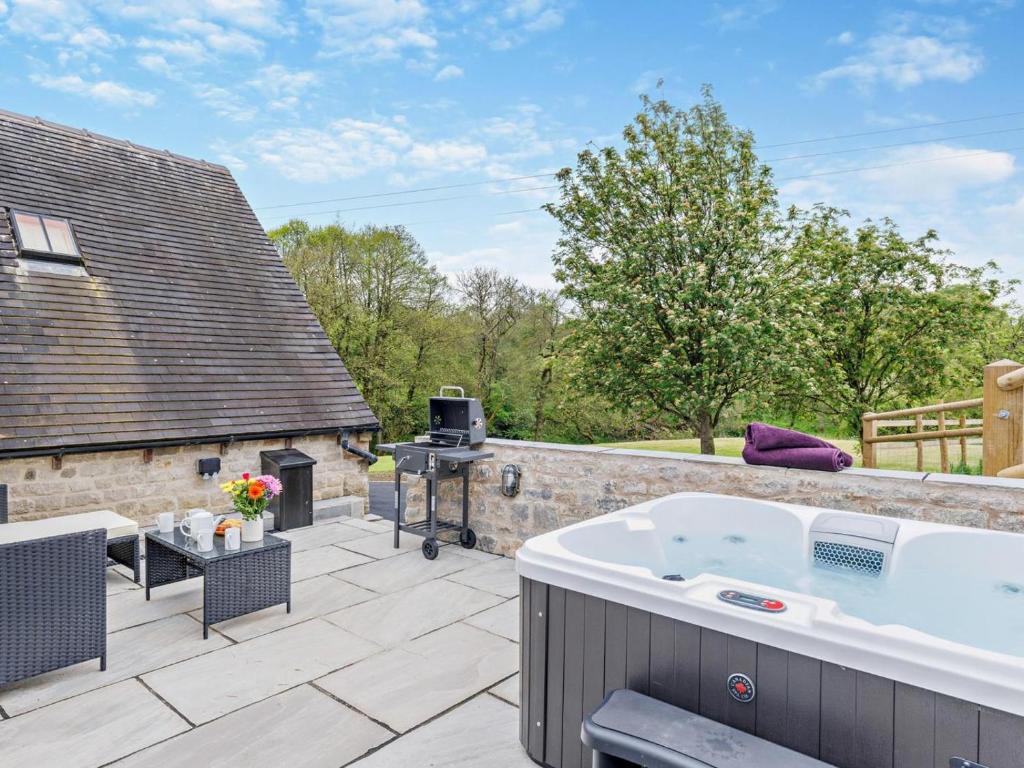 a hot tub on the patio of a house at 2 Bed in Stoke-on-trent oc-94790 in Waterhouses