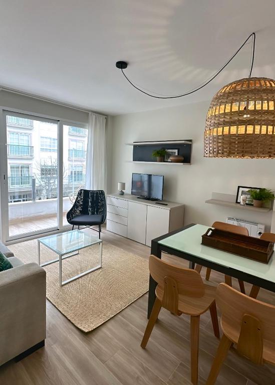 a living room with a table and a chair at Piso en el corazón de Baiona con vistas al mar in Baiona