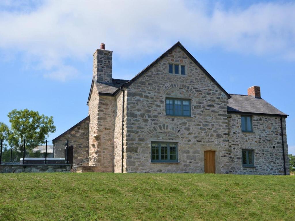 an old stone house on top of a hill at 4 Bed in Denbigh oc-62947 in Llannefydd