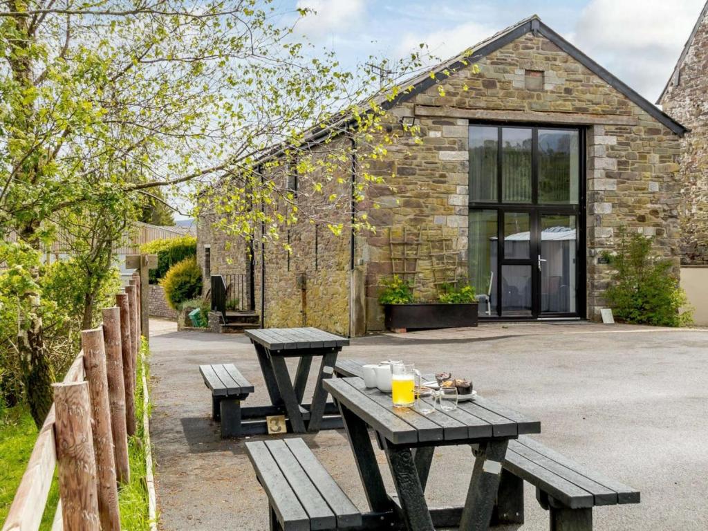 a picnic table and benches in front of a building at 1 Bed in Brecon oc-bn034 in Cray