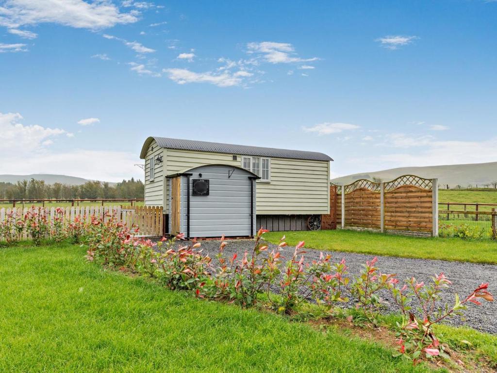 a house with a garden with flowers in the yard at 1 Bed in Rhayader oc-90277 in Saint Harmon