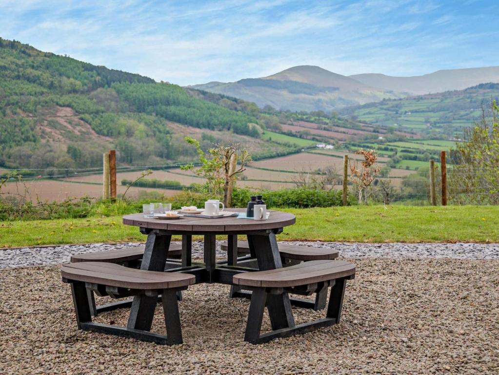 a picnic table and two benches with a view at 3 Bed in Crickhowell oc-bn124 in Tretower