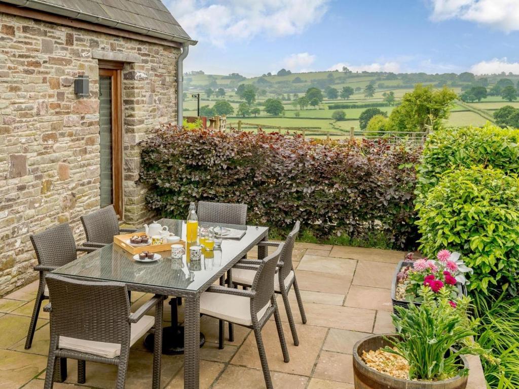a patio with a table and chairs on a patio at 3 Bed in Brecon oc-88249 in Brecon