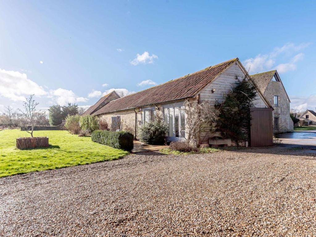 an old stone house with a gravel driveway at 2 Bed in Chippenham oc-77333 in Chippenham