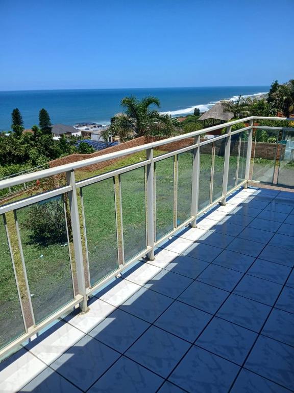 a railing on a balcony overlooking the ocean at Nomty House in Durban