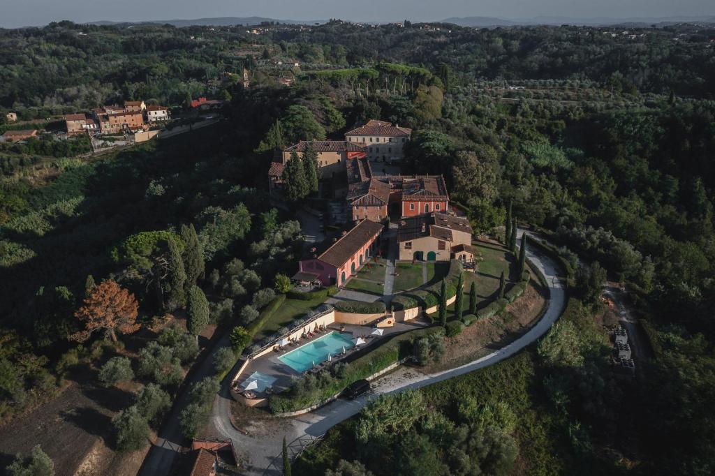 an aerial view of a mansion with a swimming pool at Borgo di Colleoli Resort in Colleoli
