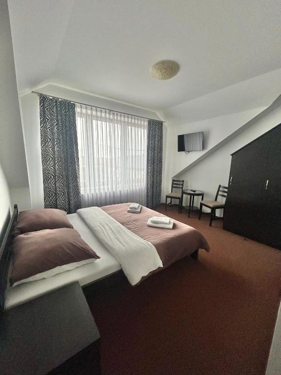 a hotel room with a bed and a window at Noclegi Kołek in Pogórze