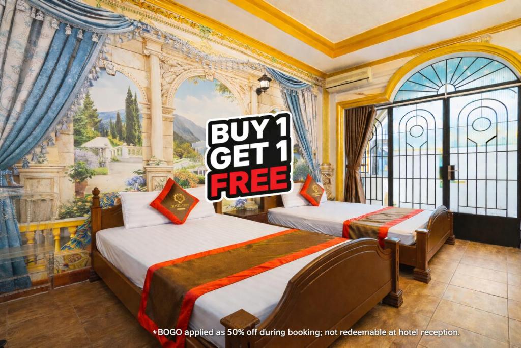 a room with two beds and a sign that says buy get free at Collection O Bao Duy Hotel in Ho Chi Minh City