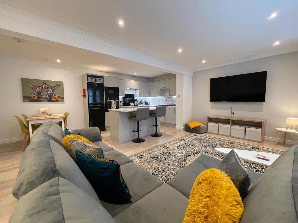 a living room with a couch and a flat screen tv at 1 The Maltings, Crail in Crail