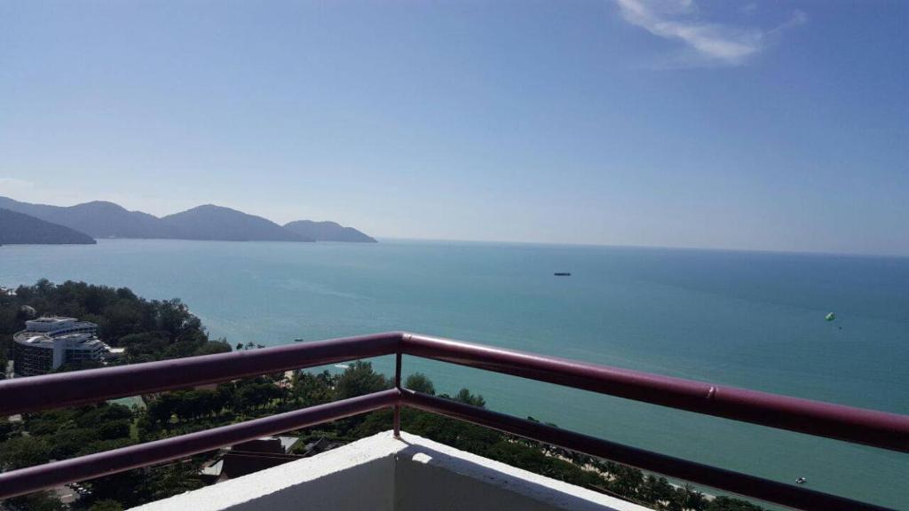 a view of the ocean from a balcony at Batu Ferringhi Seaview Apartment in Batu Ferringhi
