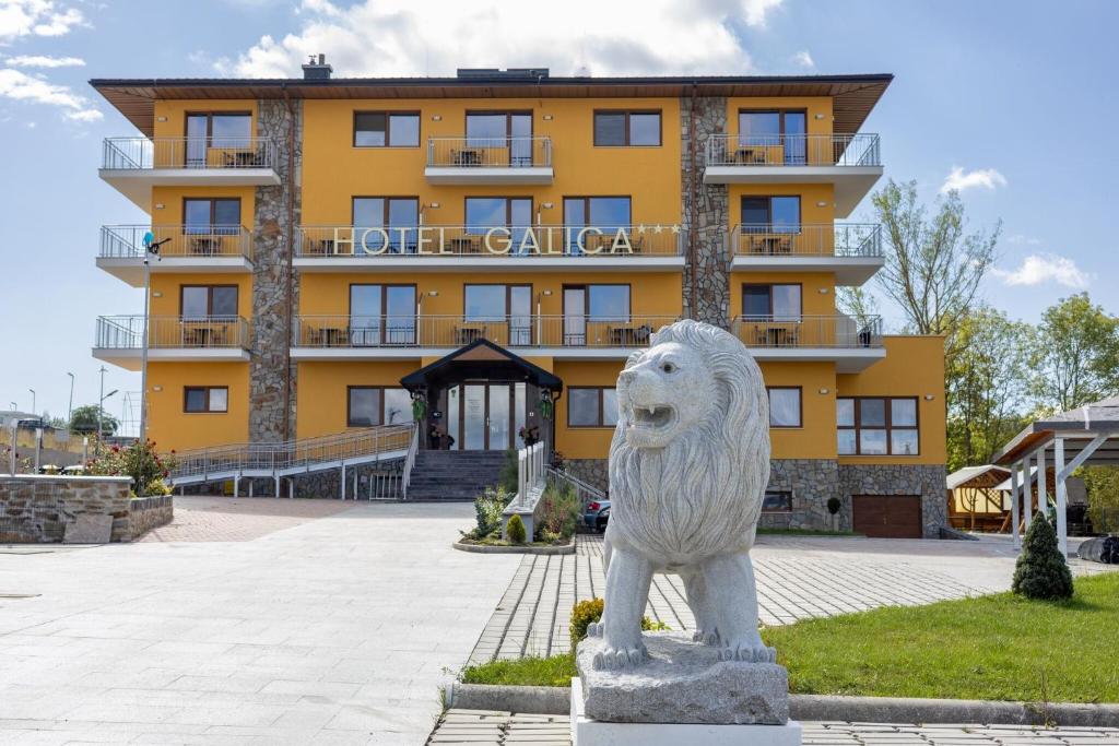a statue of a lion in front of a building at Hotel Galica in Vrbov