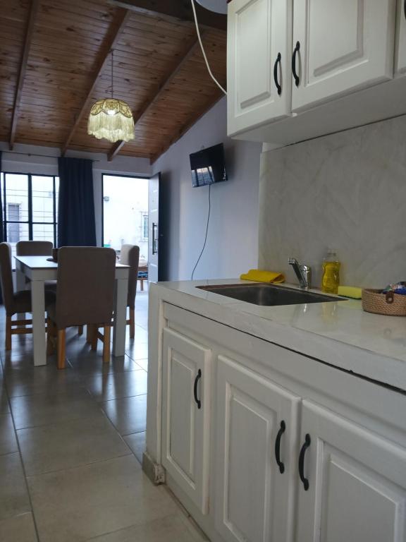 a kitchen with a sink and a dining room at merlomar1 in Merlo