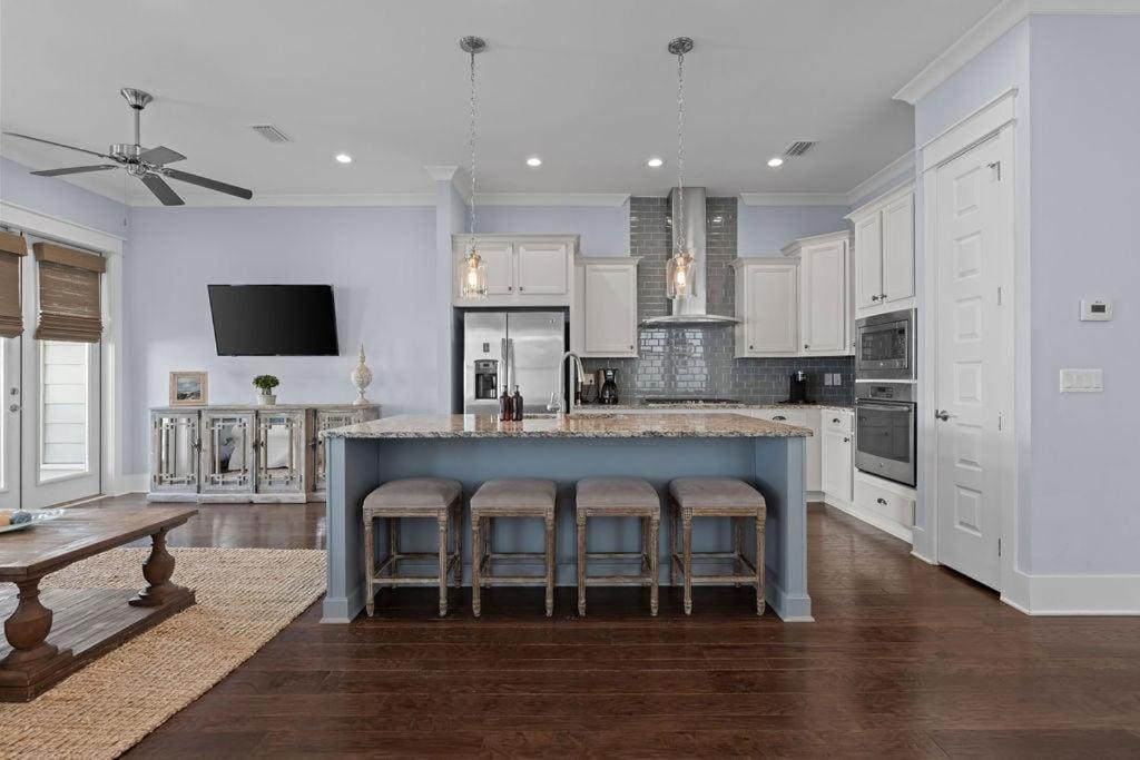 a large kitchen with a large island with bar stools at Prominence 30A - Coastal Cottage in Panama City Beach