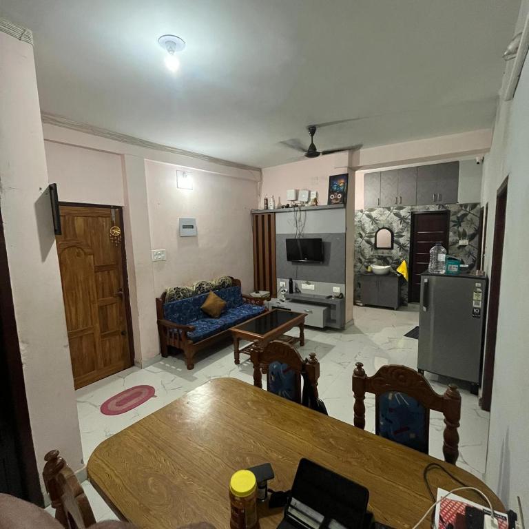 a living room with a table and a couch at The Human Nest Coliving in Bhubaneshwar