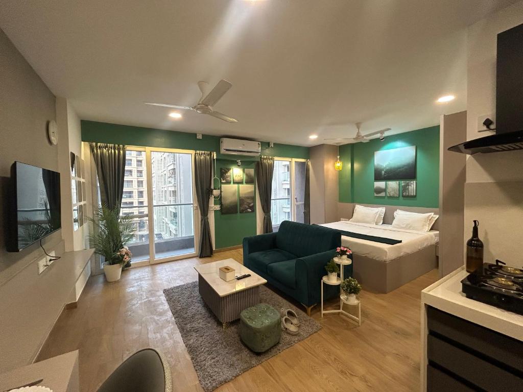 a living room with a couch and a bed in it at Casa Dune in Pune
