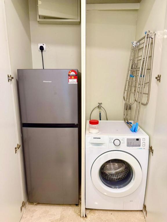 a washing machine and a washer in a room at vortex suites klcc by park view in Kuala Lumpur