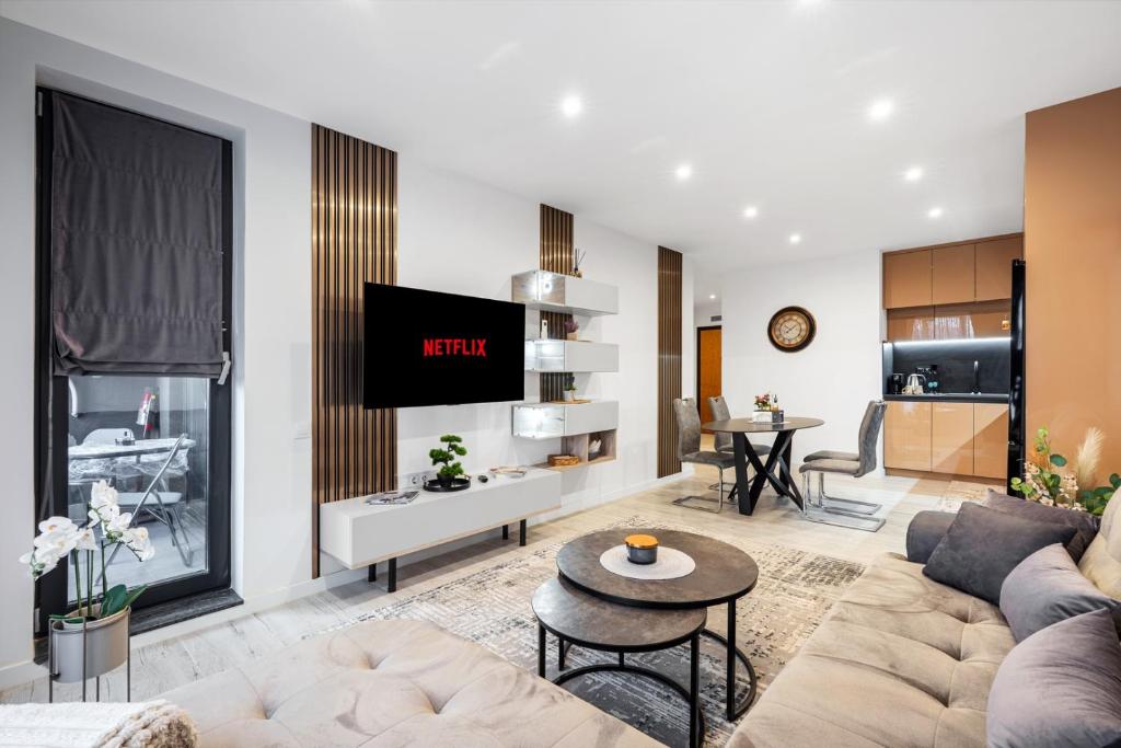 a living room with a couch and a table at Plovdiv Luxury 1BR * Free Parking * Rowing Base in Plovdiv