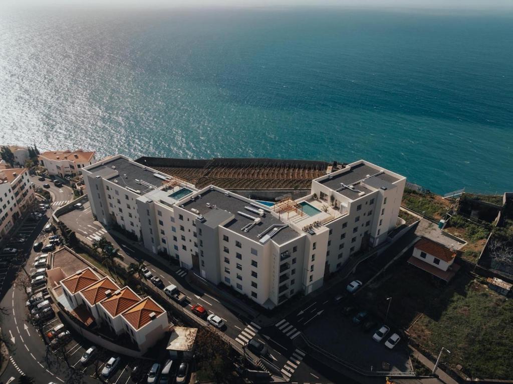 an overhead view of a building near the ocean at Atlantic Residence Pool & Ocean View in Câmara de Lobos