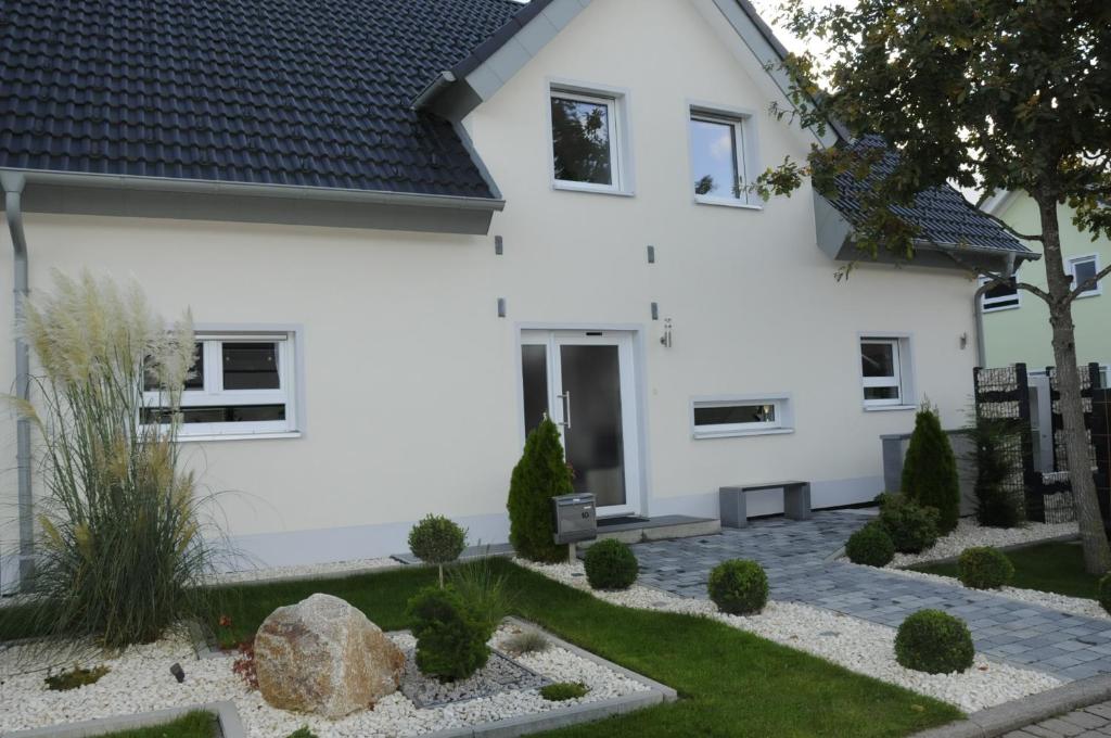 a white house with a garden in front of it at Pension Dietrich in Dobel