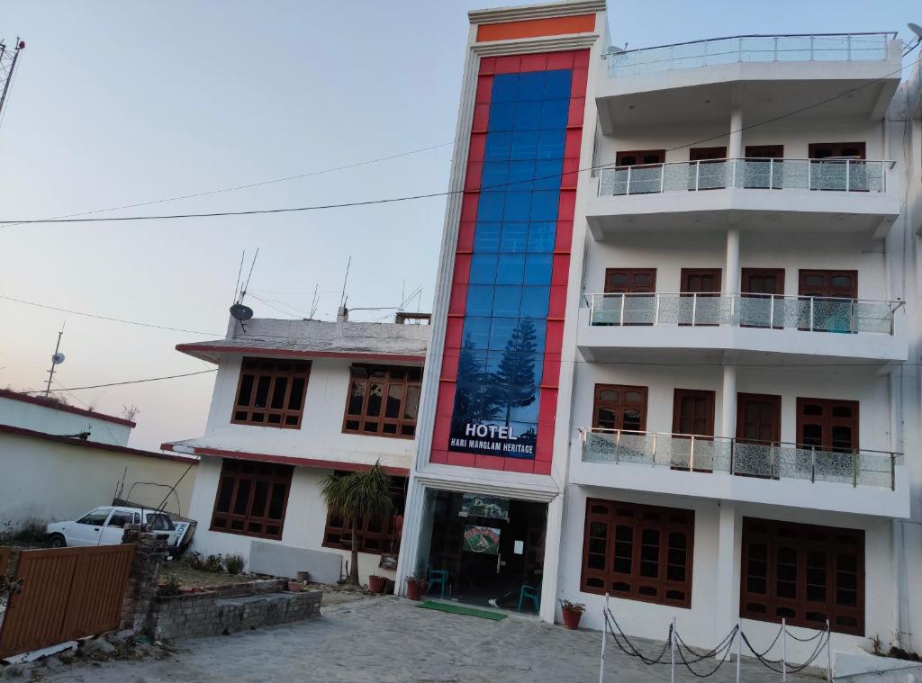 a building with a sign on the side of it at Hotel Hari mangalam heritage in Tehri-Garhwāl