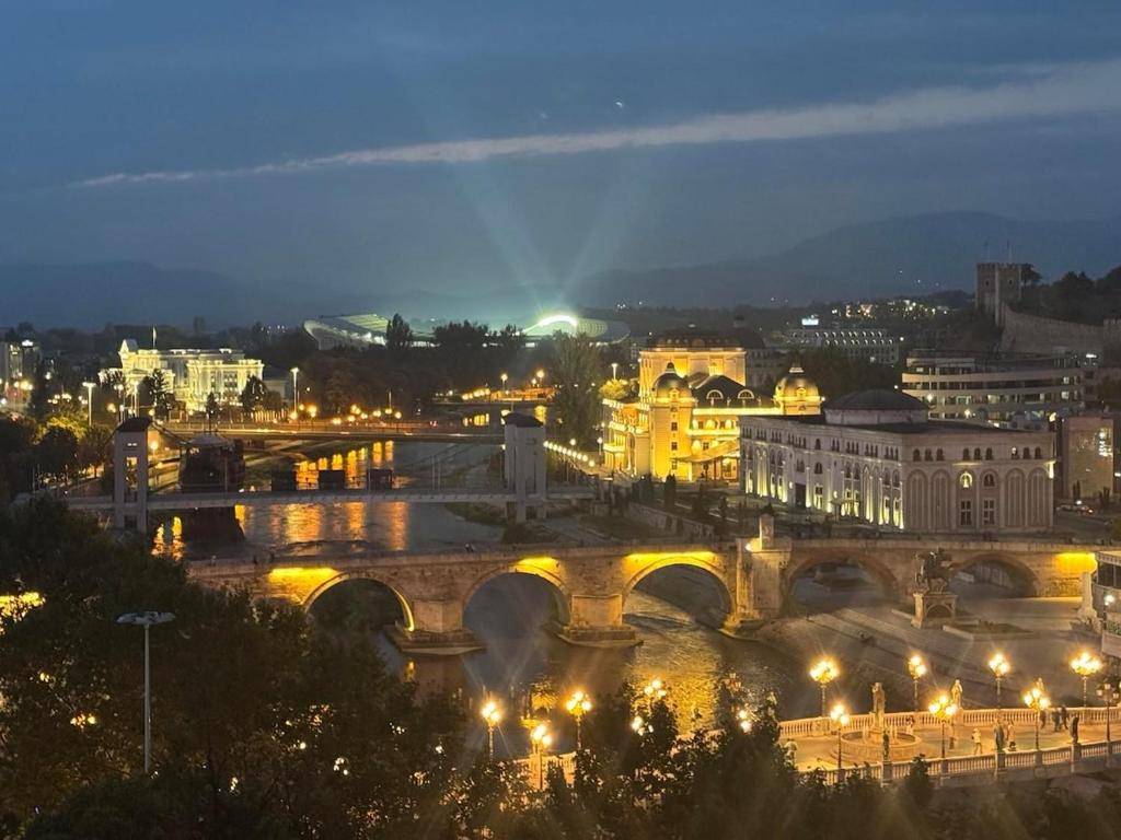 a view of a city at night with a bridge at Main Square APT with Stone Bridge & Old Bazaar View in Skopje