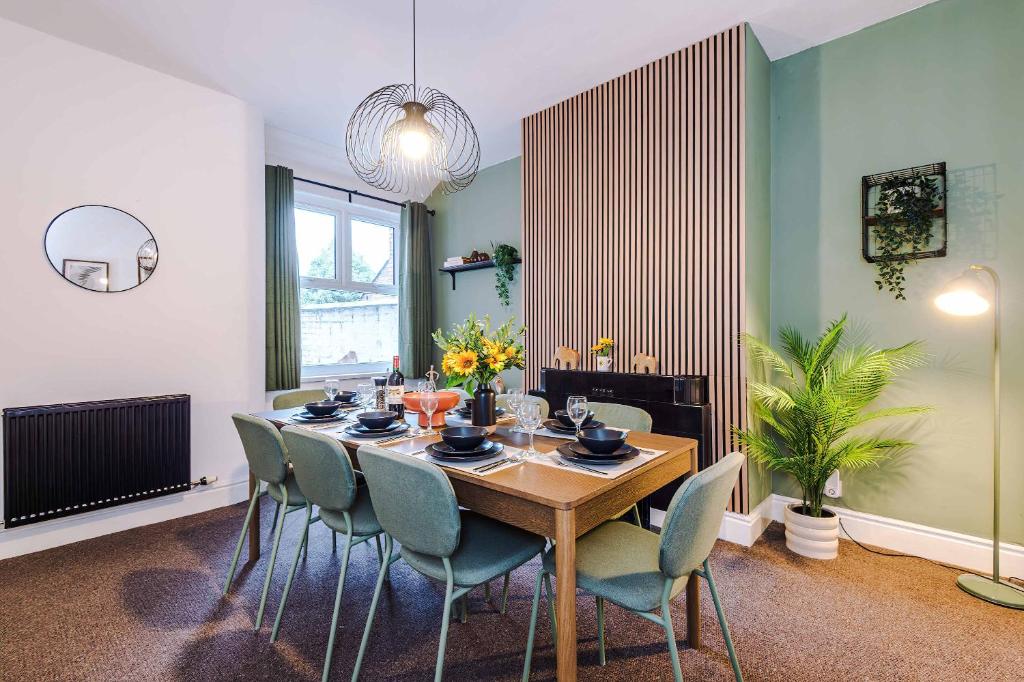 a dining room with a table and chairs at Spacious 4 Bed Home in Crewe by 53 Degrees Property! Perfect for Groups & Families in Crewe