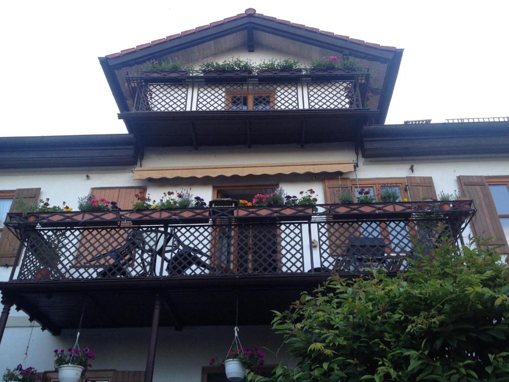 a building with a balcony with potted plants on it at Appartements am Schlossberg in Starnberg