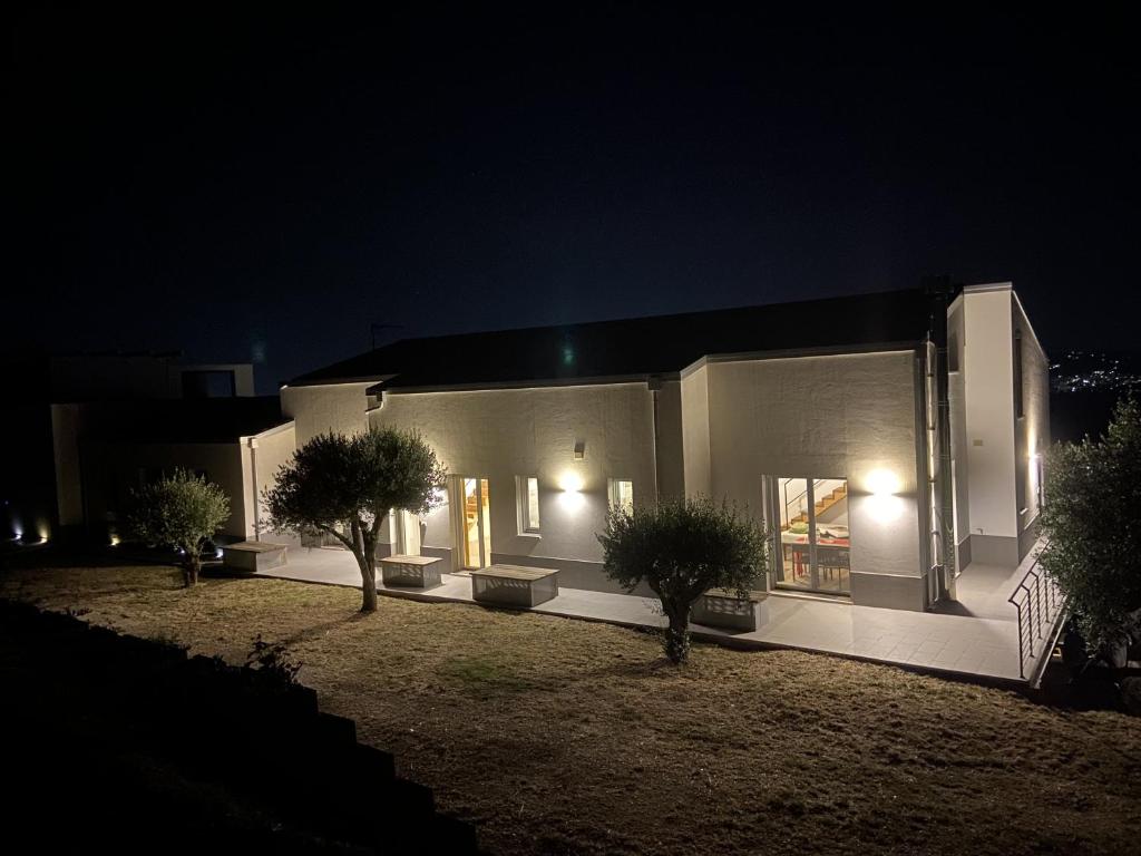 a building with two trees in front of it at night at Dimora Filippo in SantʼElpidio a Mare