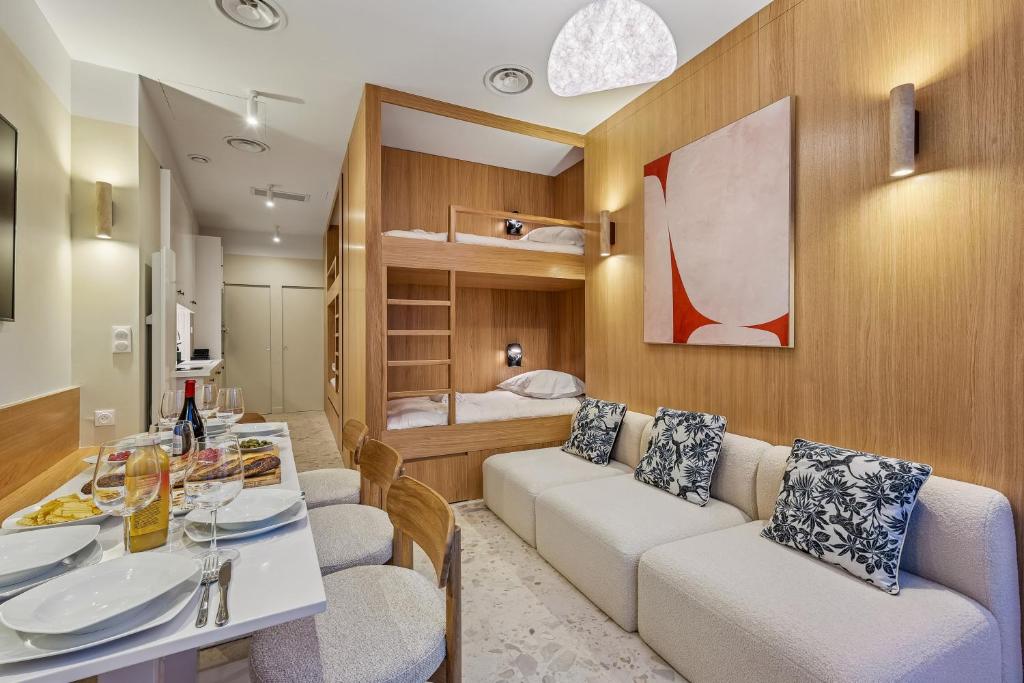 a living room with a couch and a table at Lavie Maison - Design Suite & Spa Bath in Paris