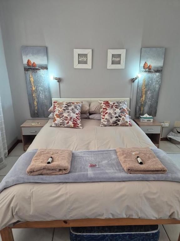 a bedroom with a bed with two towels on it at Sune's self catering 2 in Worcester
