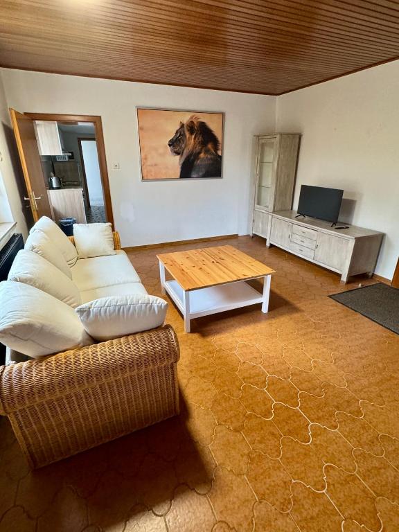 a living room with a couch and a table at Landhaus im Grünen in Mudenbach