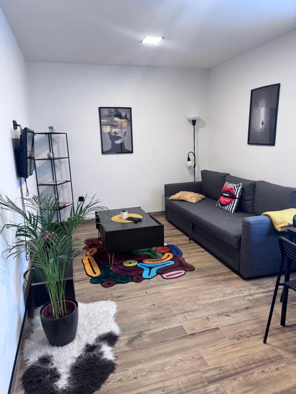 a living room with a couch and a table at j ONE Apartmány in Pardubice