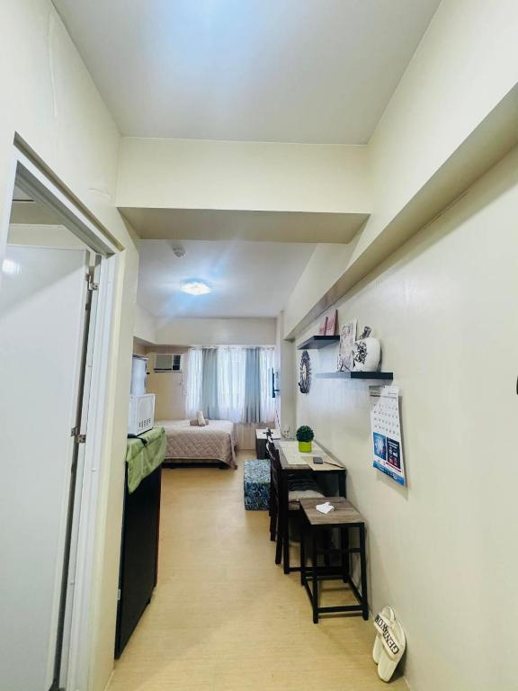 a living room with a table and a dining room at Avida towers davao condo 6thfloor in Davao City