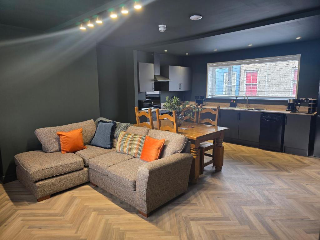 a living room with a couch and a table at The Resting Place in Aberystwyth