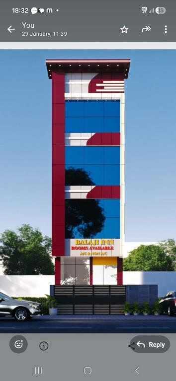 a building with a car in front of it at Balaji Inn in Vellore